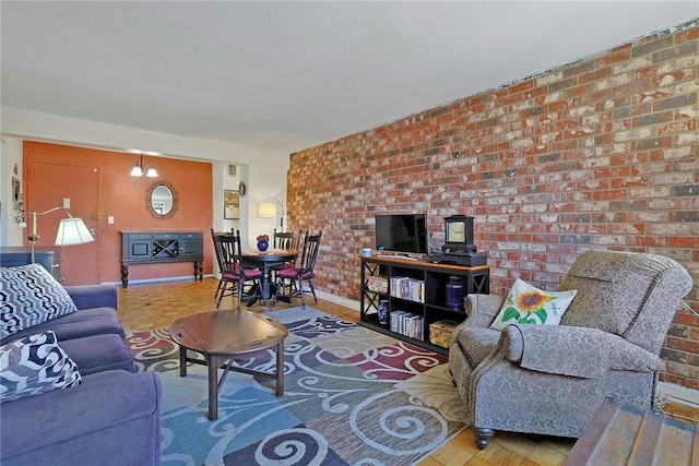 living room with brick wall and a chandelier