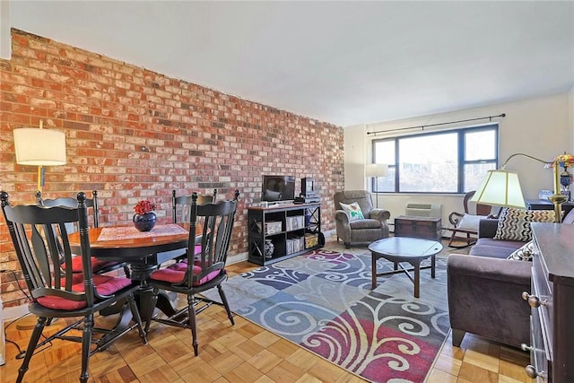 living room with brick wall and a baseboard heating unit