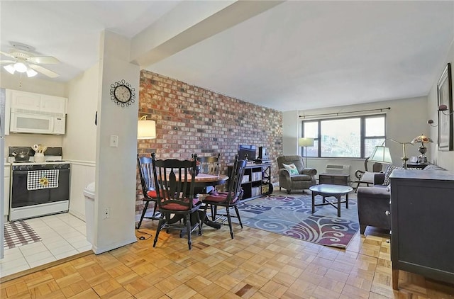 living room with ceiling fan and brick wall