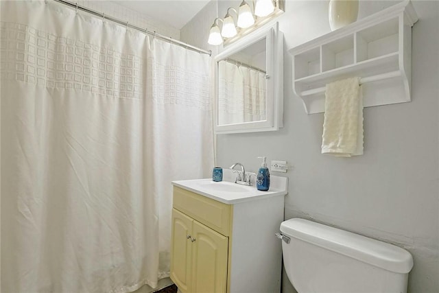 bathroom with vanity, toilet, and walk in shower