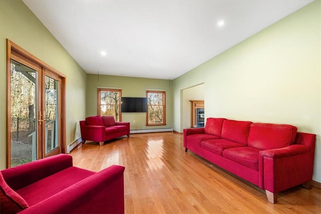 living room featuring light hardwood / wood-style floors and a baseboard heating unit