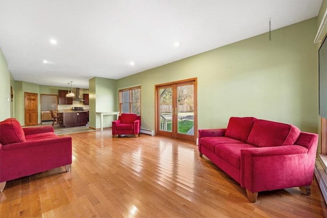 living room with a baseboard heating unit, french doors, and light hardwood / wood-style flooring