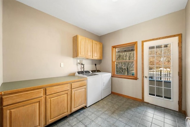 laundry area featuring cabinets, light tile patterned floors, and washer and dryer