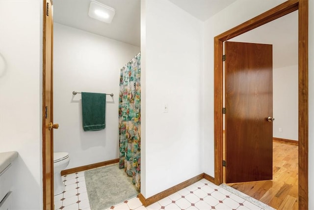 bathroom with toilet, wood-type flooring, and walk in shower