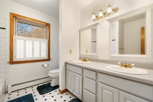 bathroom with vanity, toilet, and baseboard heating