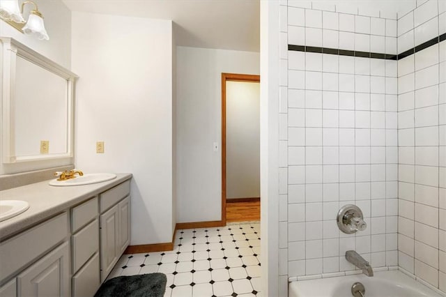 bathroom featuring vanity and tiled shower / bath