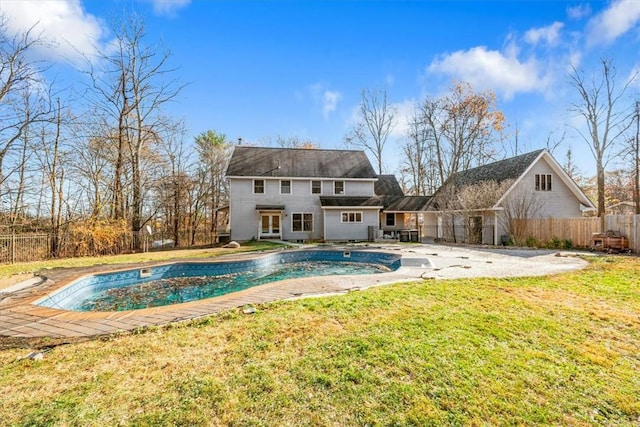 view of pool with a patio area and a yard