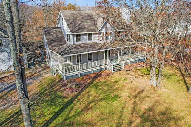 farmhouse with a porch and a front lawn