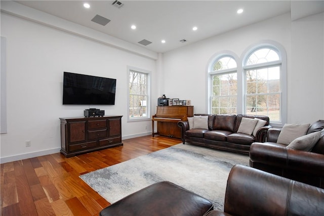 living room with plenty of natural light and light hardwood / wood-style flooring