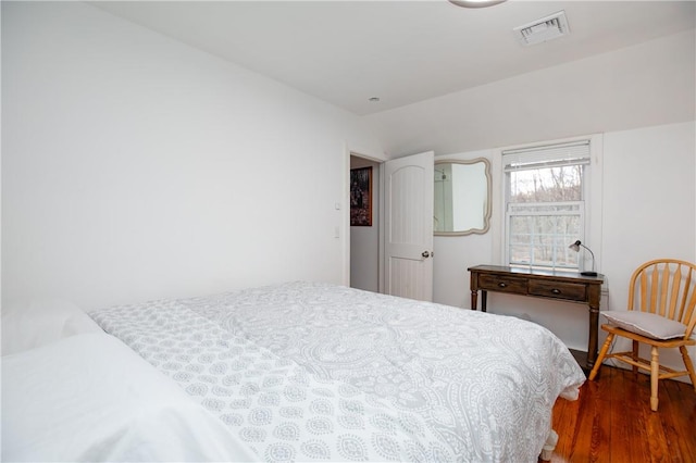 bedroom with dark hardwood / wood-style flooring