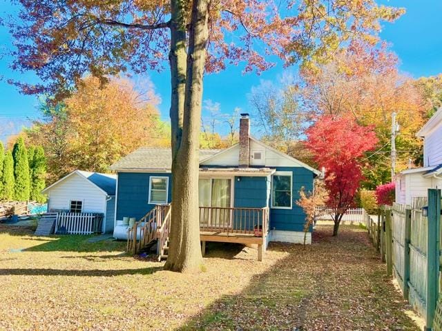 back of property with a lawn