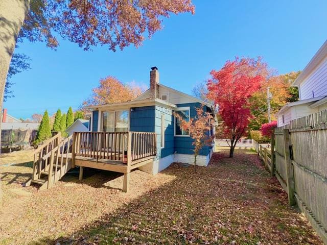 rear view of property with a wooden deck