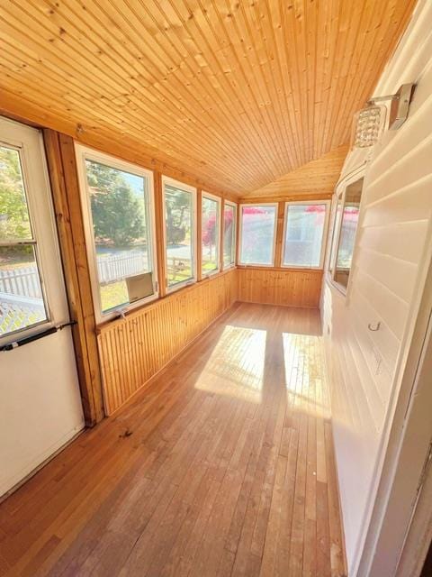 unfurnished sunroom featuring wooden ceiling and vaulted ceiling