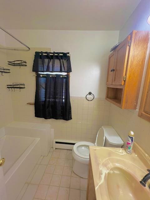 bathroom featuring a baseboard heating unit, sink, tile patterned flooring, toilet, and tile walls