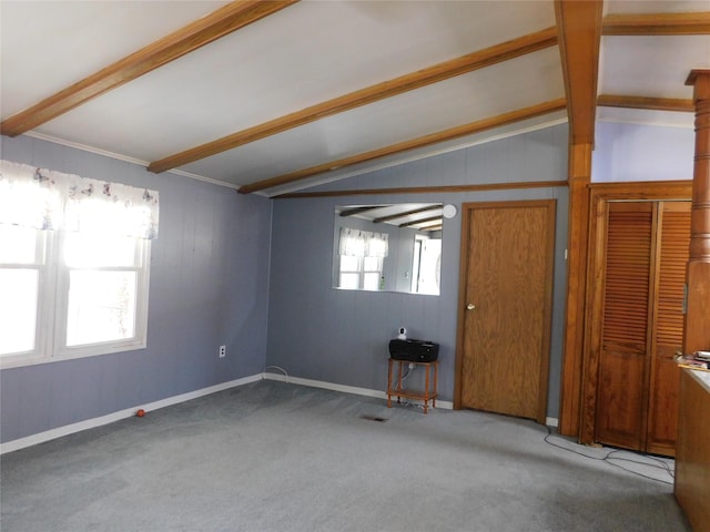 carpeted spare room with lofted ceiling with beams