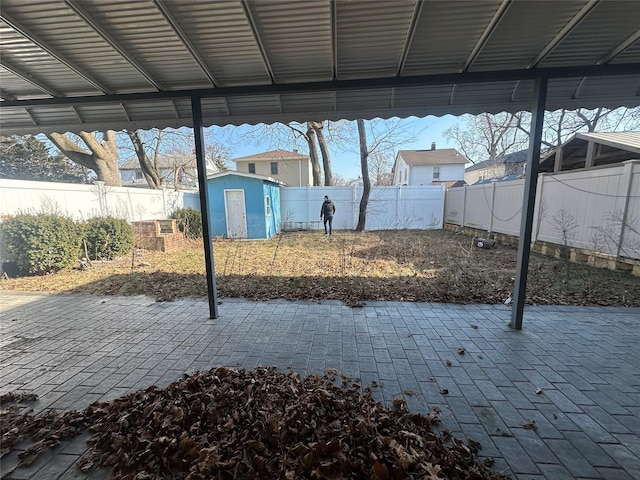 view of patio featuring a storage unit