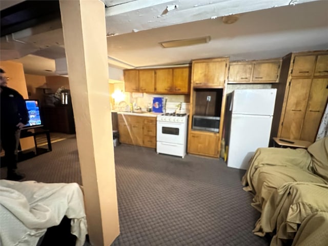 kitchen with white appliances and dark colored carpet