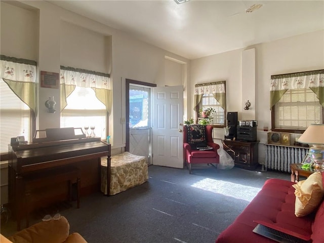 living room with dark colored carpet and radiator