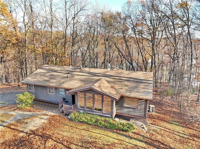 view of front facade featuring central AC and a sunroom