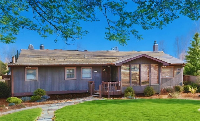 back of house with a lawn