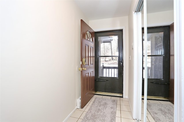 doorway to outside with light tile patterned floors