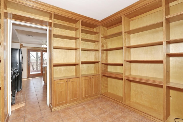 interior space with ceiling fan