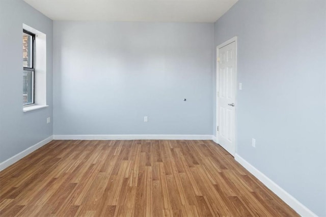 spare room with light hardwood / wood-style flooring and plenty of natural light