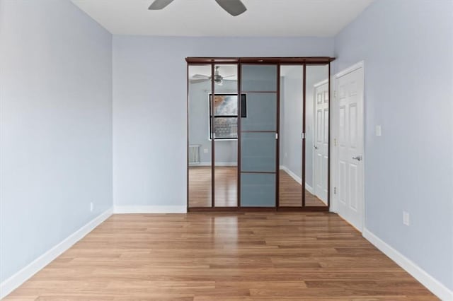 unfurnished bedroom with light wood-type flooring and ceiling fan