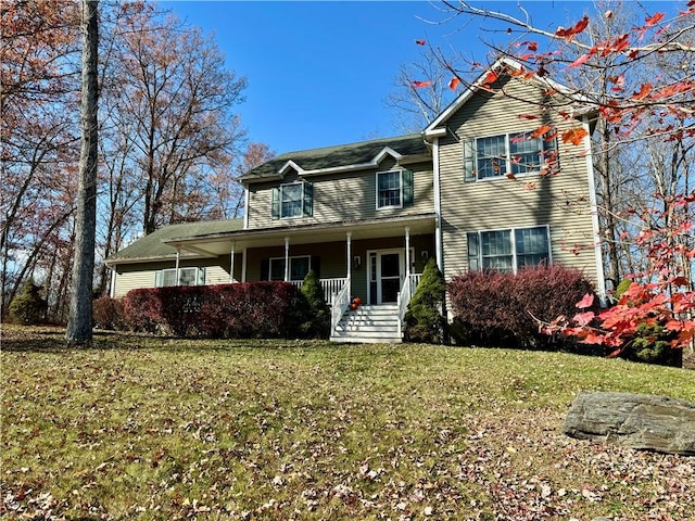 view of front of property with covered porch and a front yard