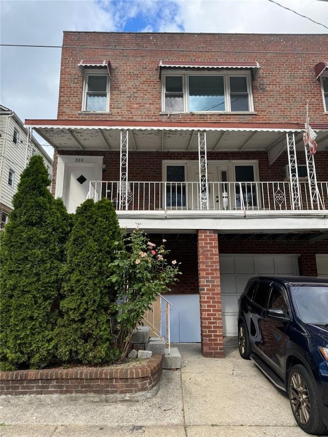 view of property with a balcony and a garage