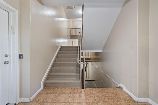 stairs with tile patterned floors