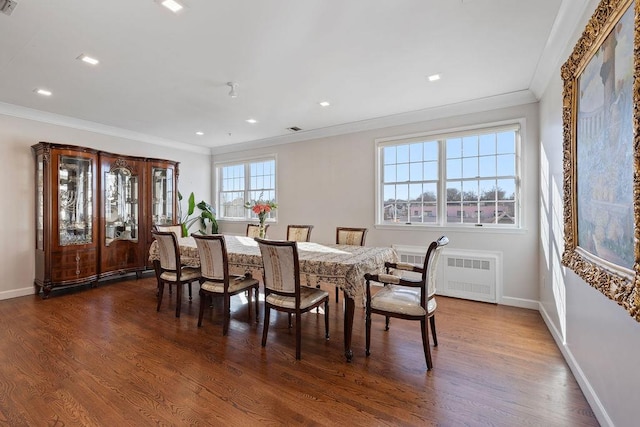 dining room featuring radiator, dark hardwood / wood-style flooring, and a healthy amount of sunlight