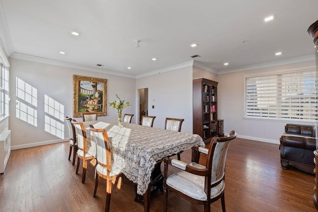 dining area featuring crown molding and dark wood-type flooring