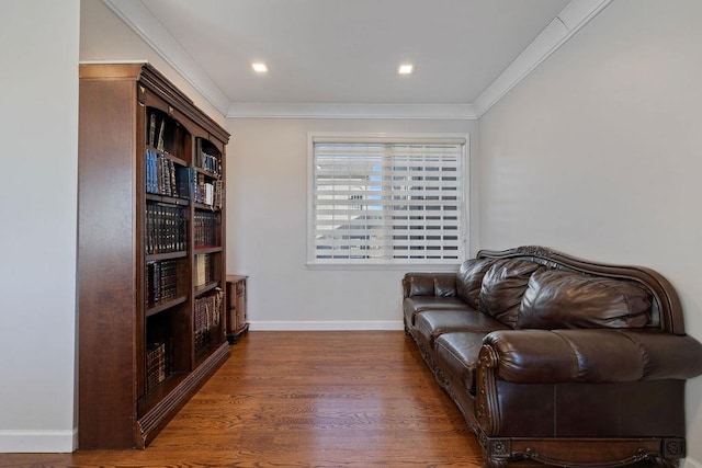 living area with crown molding and dark wood-type flooring