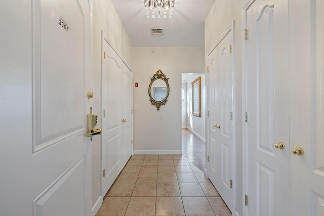 doorway with light tile patterned flooring