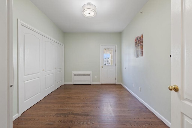 entrance foyer featuring radiator heating unit and dark wood-type flooring