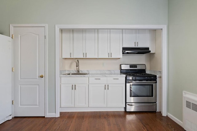 kitchen with stainless steel gas range oven, white cabinetry, sink, and dark hardwood / wood-style flooring