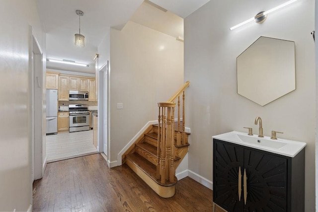 stairs with sink and wood-type flooring