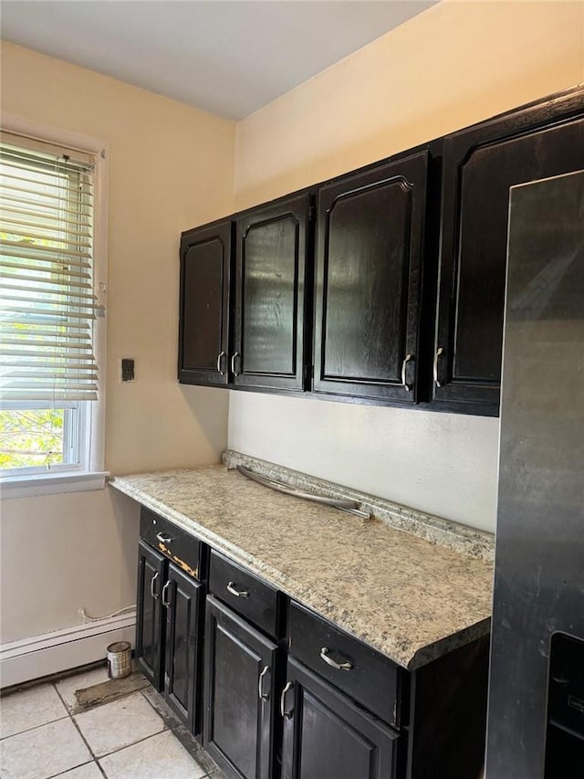 kitchen featuring light tile patterned floors and a baseboard radiator