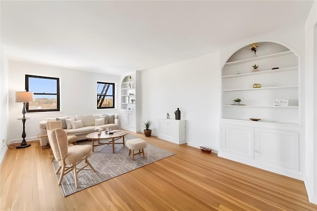 living room with hardwood / wood-style flooring and built in features