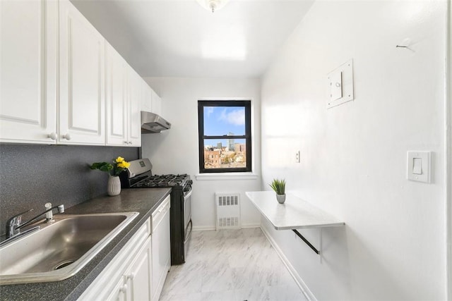 kitchen featuring white dishwasher, sink, stainless steel gas stove, tasteful backsplash, and white cabinetry