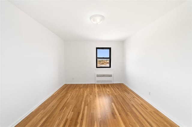 19 Old Mamaroneck Rd Unit 6D, White Plains, NY 10605 - unfurnished room with radiator heating unit, light wood finished floors, and baseboards