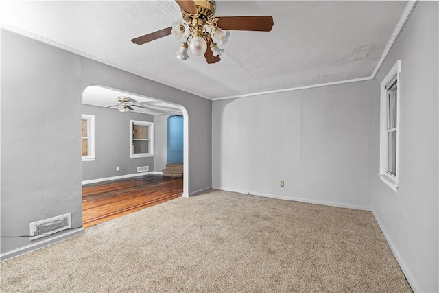 empty room featuring carpet flooring, ceiling fan, and ornamental molding