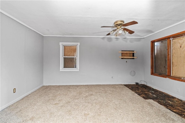 spare room featuring carpet flooring, crown molding, and ceiling fan