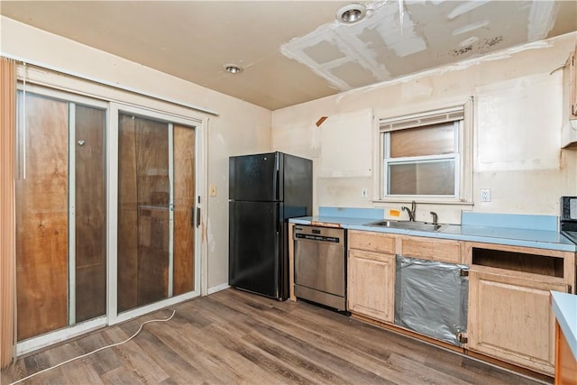 kitchen featuring dishwasher, light brown cabinets, dark wood-type flooring, sink, and black fridge