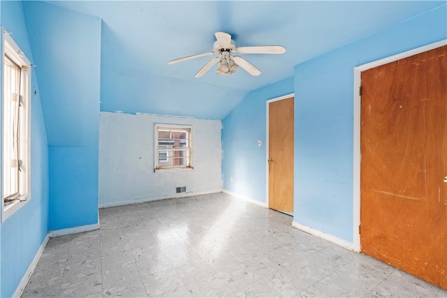 additional living space with ceiling fan and vaulted ceiling