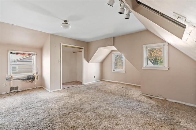 bonus room featuring light carpet and lofted ceiling