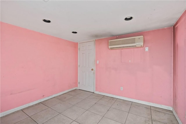 tiled spare room with a wall unit AC