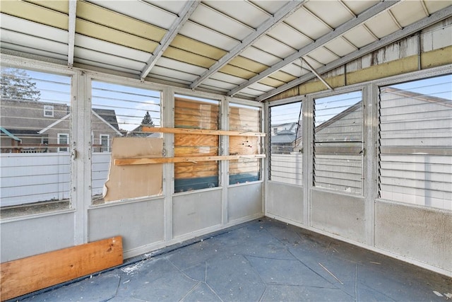 unfurnished sunroom with vaulted ceiling