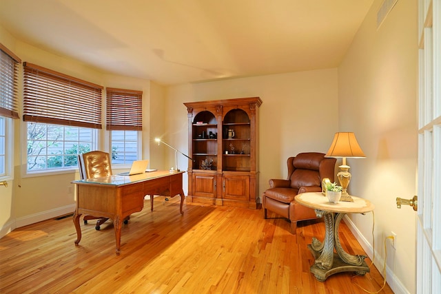 office area with light hardwood / wood-style floors